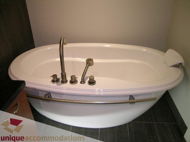 Bathroom with modern bathtub and sleek faucet. - 1302 - 3355 Cypress Pl, West Vancouver