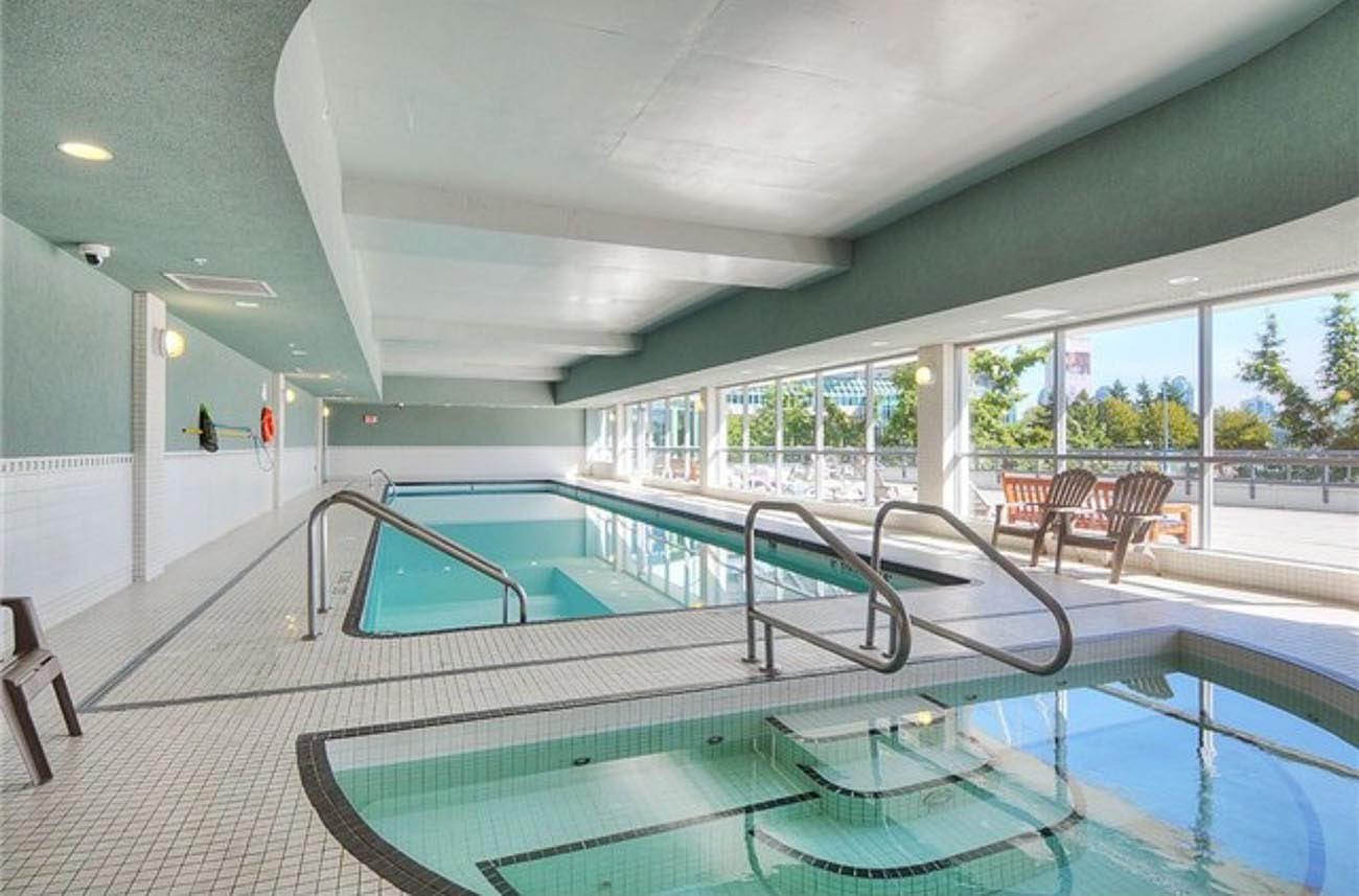 Indoor pool with stainless steel entry rails and panoramic city views. - 3209 - 928 Beatty Street, Vancouver Downtown