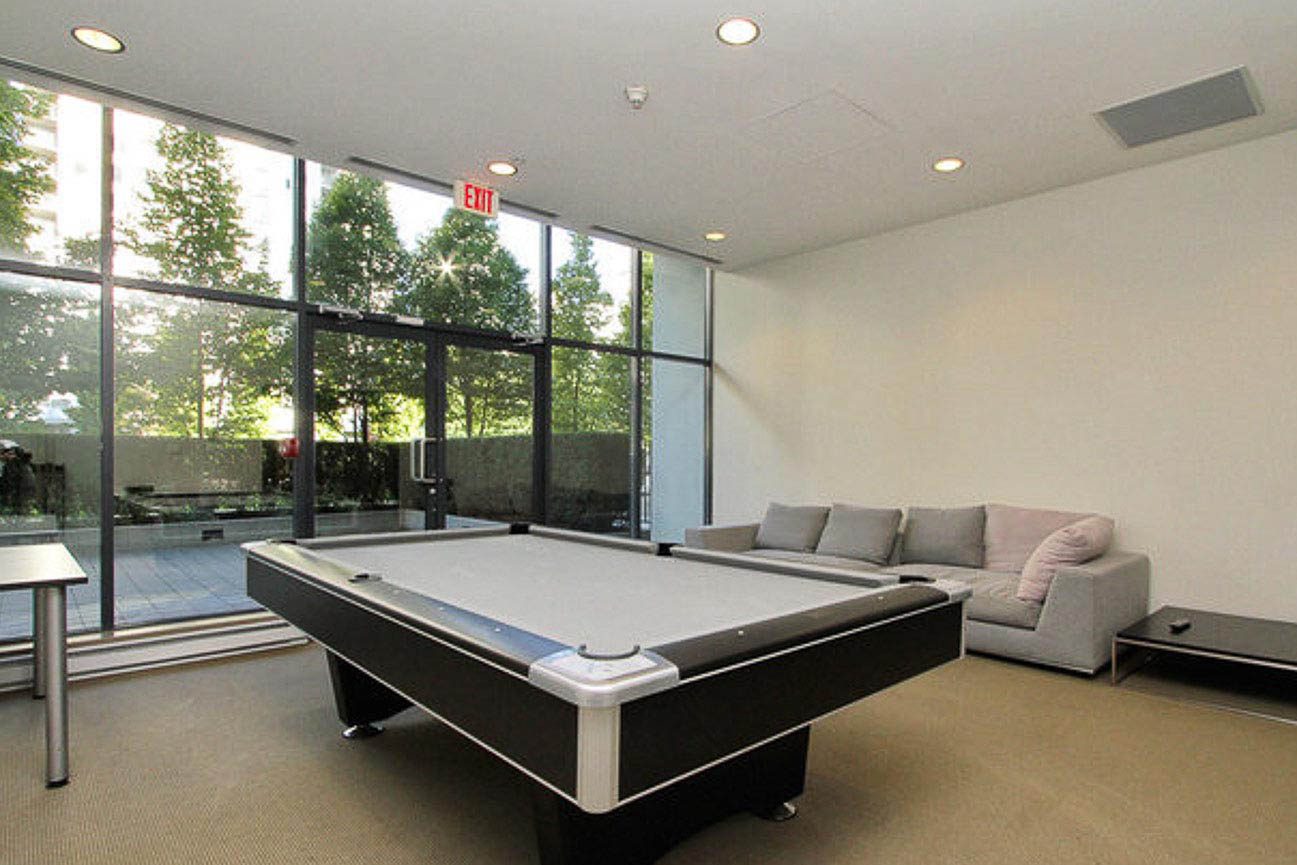 Game room with modern pool table and panoramic city views through floor-to-ceiling windows. - 3209 - 928 Beatty Street, Vancouver Downtown