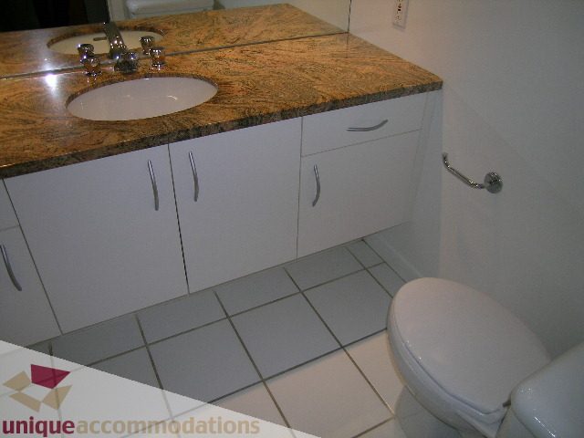 Bathroom with granite countertop and white cabinets. - 402-1155 Mainland St, Vancouver Downtown