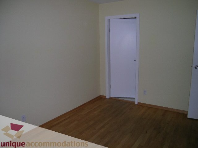 Bright living room with hardwood floors and white walls. - 402-1155 Mainland St, Vancouver Downtown