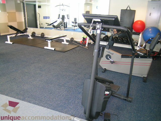 Bright gym with exercise equipment and mirrors. - 3003 - 501 Pacific Street, Vancouver Downtown