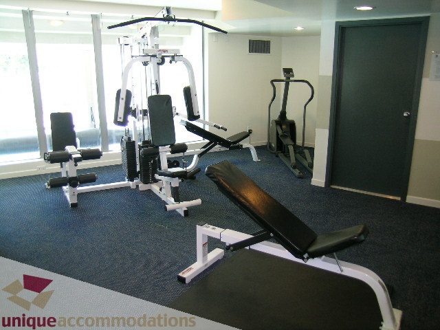 Fitness room with weight machines and cardio equipment. - 3003 - 501 Pacific Street, Vancouver Downtown