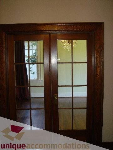 Entryway with wooden double doors and glass panels, leading to a bright interior space. - 1475 W 33rd Ave, Vancouver West Side