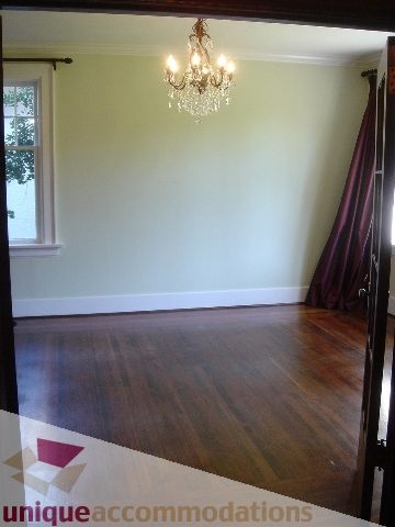Furnished living room with hardwood floors and elegant chandelier. - 1475 W 33rd Ave, Vancouver West Side