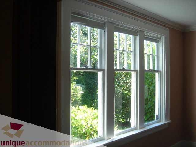 Bright living room with large windows, greenery outside, hardwood floors. - 1475 W 33rd Ave, Vancouver West Side