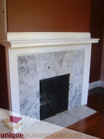 Furnished living room with marble fireplace and hardwood floors. - 1475 W 33rd Ave, Vancouver West Side