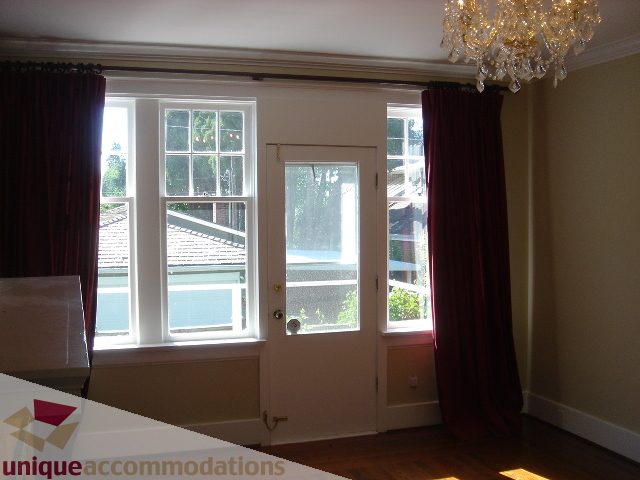 Bright living room with hardwood floors, large windows, and a chandelier. - 1475 W 33rd Ave, Vancouver West Side