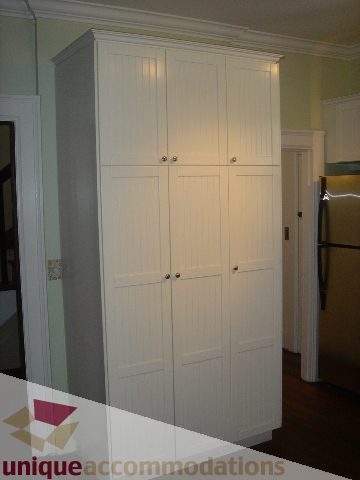 Furnished bedroom with white closet doors and hardwood floors. - 1475 W 33rd Ave, Vancouver West Side