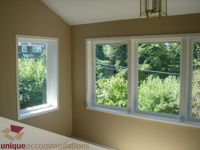 Bright bedroom with large windows and a view of greenery. - 1475 W 33rd Ave, Vancouver West Side