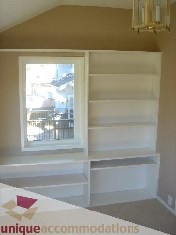 Bright living room with built-in shelves and city view. - 1475 W 33rd Ave, Vancouver West Side