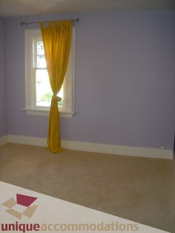 Bright bedroom with purple walls and yellow curtains. - 1475 W 33rd Ave, Vancouver West Side