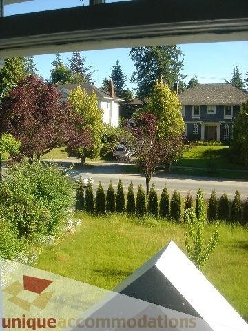 Furnished living room with a view of greenery and houses. - 1475 W 33rd Ave, Vancouver West Side