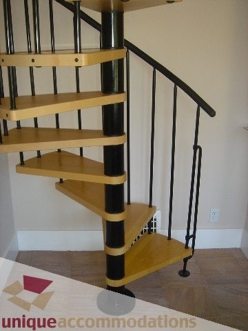 Staircase with wooden treads and black railings leading to upper floor. - 1475 W 33rd Ave, Vancouver West Side