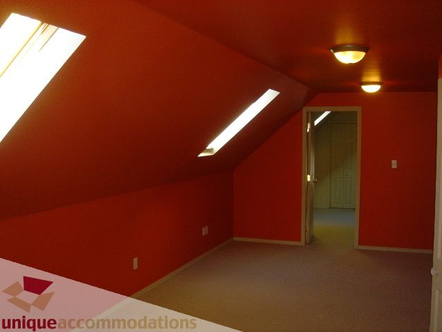Attic bedroom with slanted ceiling and natural light from skylights. - 1475 W 33rd Ave, Vancouver West Side