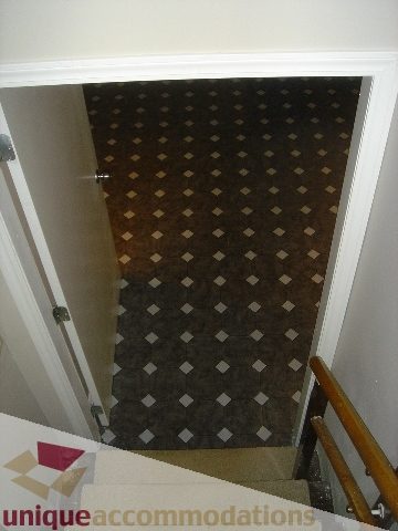 Foyer with checkered floor pattern and wooden handrail. - 1475 W 33rd Ave, Vancouver West Side