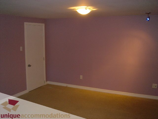Empty bedroom with carpeted floor and white door. - 1475 W 33rd Ave, Vancouver West Side