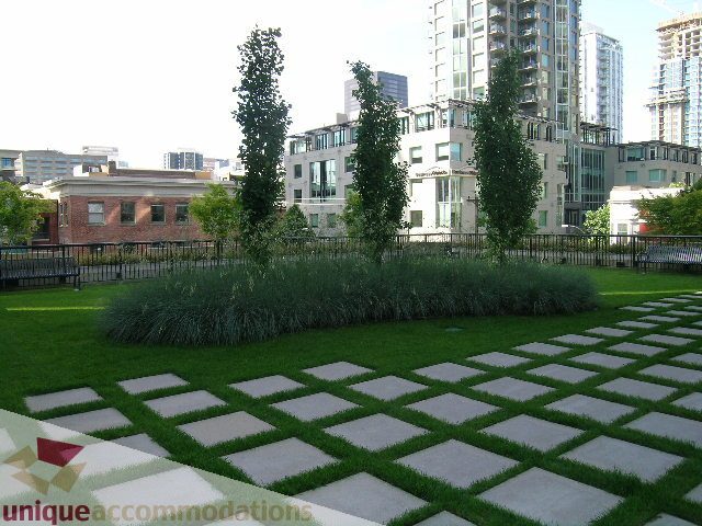 Furnished living room with city view and modern decor. - 2707 - 928 Homer Street, Vancouver Downtown
