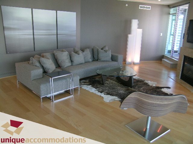 Furnished living room with hardwood floors, modern furniture, and large wall art. - 1603-1650 Bayshore Drive, Vancouver Downtown