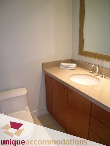 Furnished bathroom with wooden cabinets and a modern sink. - 1603-1650 Bayshore Drive, Vancouver Downtown