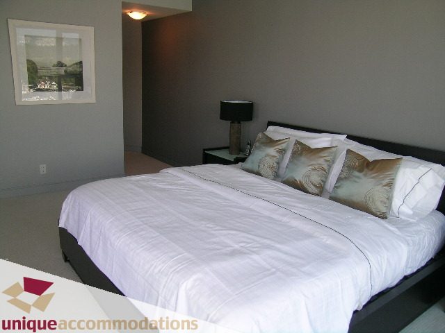 Spacious bedroom with neatly made beds and decorative pillows. - 1603-1650 Bayshore Drive, Vancouver Downtown