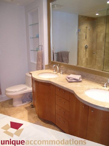 Furnished bathroom with marble countertops and wooden cabinets. - 1603-1650 Bayshore Drive, Vancouver Downtown