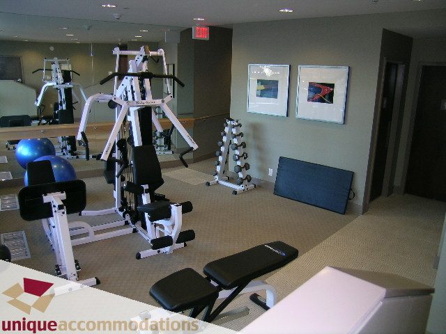 Bright gym with exercise equipment and framed artwork on the wall. - 1603-1650 Bayshore Drive, Vancouver Downtown