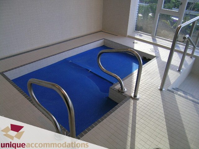 Spacious indoor pool with blue tiles and metal handrails. - 1603-1650 Bayshore Drive, Vancouver Downtown