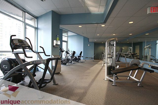 Bright gym with cardio machines and weight equipment, city view. - 1207 - 1155 Seymour Street, Vancouver Downtown