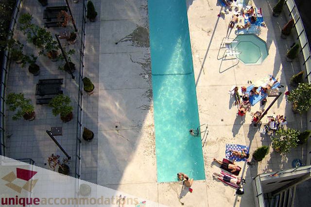 Furnished balcony with outdoor pool and seating area. - 1207 - 1155 Seymour Street, Vancouver Downtown