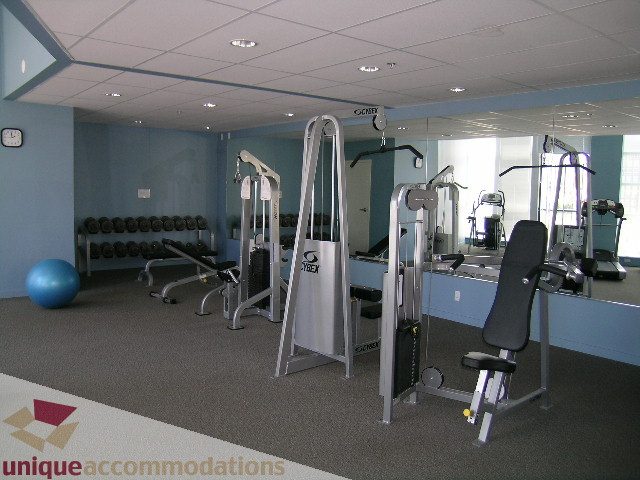 Furnished gym with weight machines and mirrors, clean and organized. - 1207 - 1155 Seymour Street, Vancouver Downtown