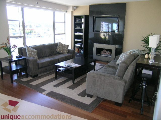 Spacious living room with hardwood floors, city view, and modern furniture. - 602-1012 Beach Ave., Vancouver Downtown