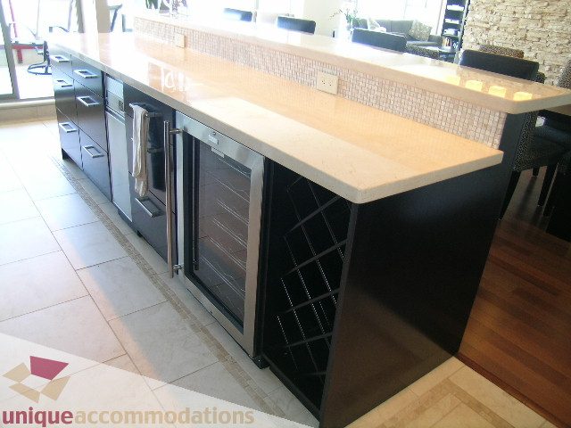 Bright kitchen with light stone countertops and black cabinetry, showcasing a modern design. - 602-1012 Beach Ave., Vancouver Downtown