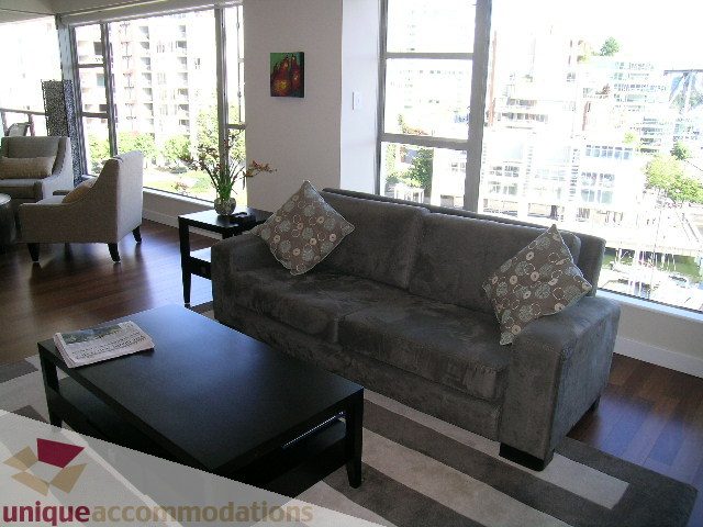 Furnished living room with hardwood floors, city view, and modern decor. - 602-1012 Beach Ave., Vancouver Downtown