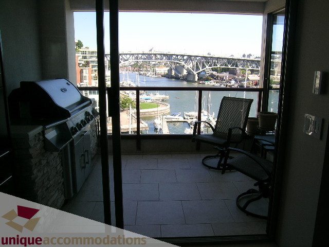 Bright living room with city view and outdoor grill, perfect for downtown living. - 602-1012 Beach Ave., Vancouver Downtown