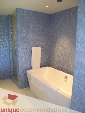 Spacious bathroom with blue mosaic tiles and a modern bathtub. - 602-1012 Beach Ave., Vancouver Downtown