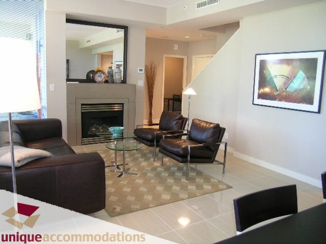 Spacious living room with modern decor, large artwork, and cozy seating. - 103-638 Beach Cres., Vancouver Downtown