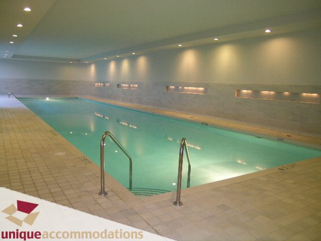 Spacious indoor pool area with tiled flooring and modern lighting fixtures. - 103-638 Beach Cres., Vancouver Downtown