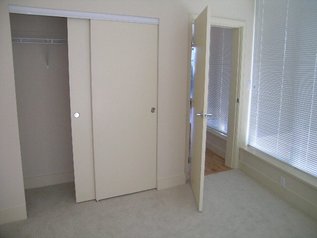 Bright bedroom with sliding closet doors and large windows with blinds. - 803 - 1616 Bayshore Drive, Vancouver Downtown