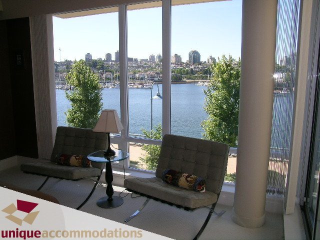Living room with a stunning city view and modern furnishings. - 103 - 1515 Homer Mews, Vancouver Downtown