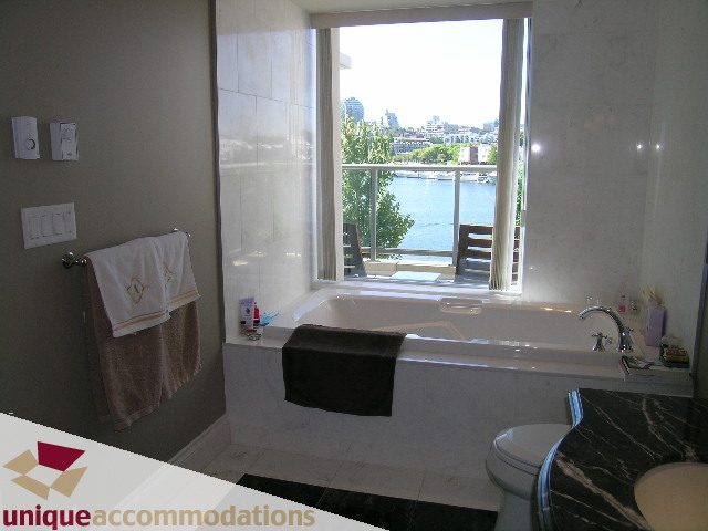 Bathroom with marble countertops, city view, and modern fixtures. - 103 - 1515 Homer Mews, Vancouver Downtown