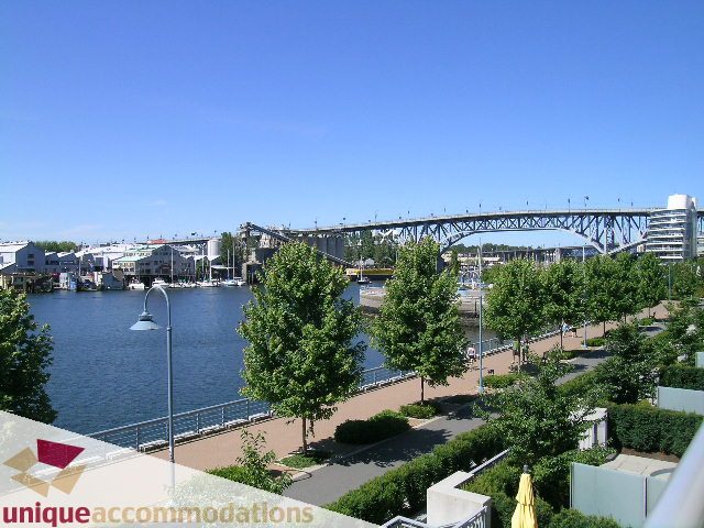 Bright living room with city view and waterfront access. - 103 - 1515 Homer Mews, Vancouver Downtown