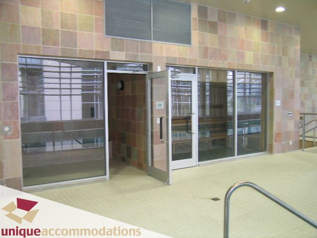 Bright entrance with glass doors and tiled walls. - 103 - 1515 Homer Mews, Vancouver Downtown