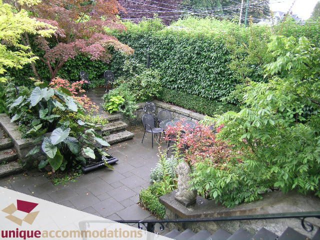 Furnished patio with lush greenery and outdoor seating. - 3447 West 1st Avenue, Vancouver West Side