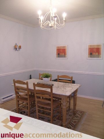 Furnished dining area with marble countertops and hardwood floors. - 304 - 1281 Parkgate Avenue, North Vancouver