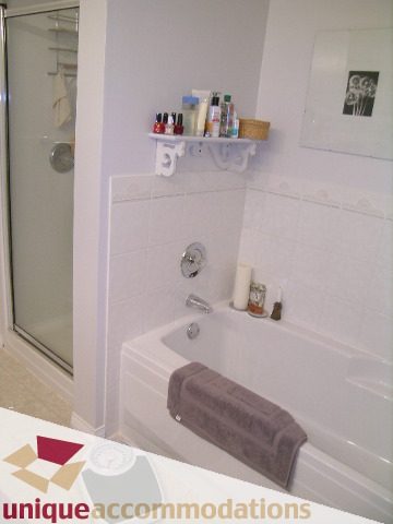 Furnished bathroom with white tile, countertop, and towel rack. - 304 - 1281 Parkgate Avenue, North Vancouver