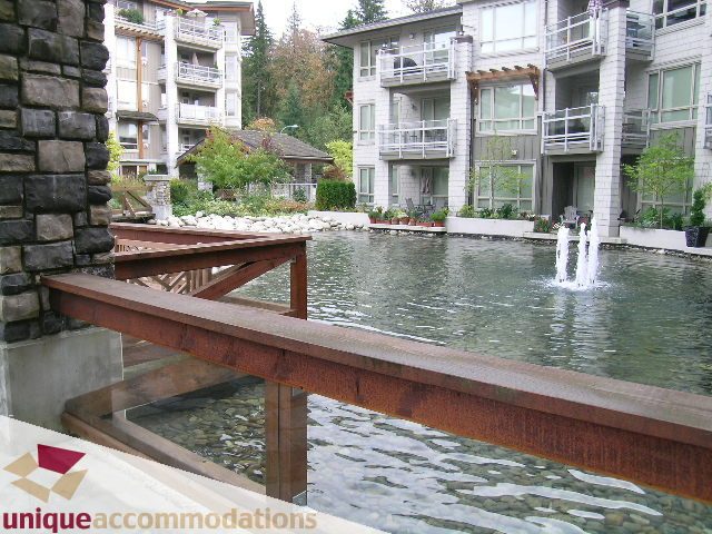 Spacious 1-bedroom + den condo with a serene water feature and modern furnishings. - 105 - 530 Raven Woods, North Vancouver