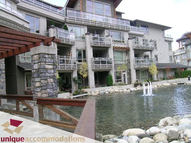 Spacious 1-bedroom + den condo with balcony overlooking serene water and lush greenery. - 105 - 530 Raven Woods, North Vancouver