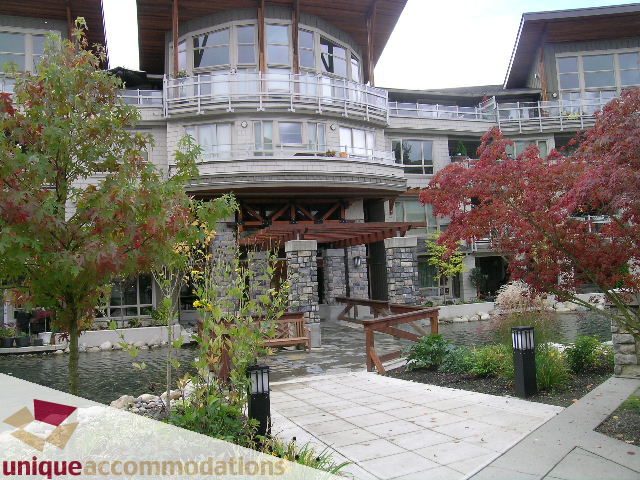 Spacious 1-bedroom + den condo with modern furnishings, large windows, and a cozy balcony. - 105 - 530 Raven Woods, North Vancouver