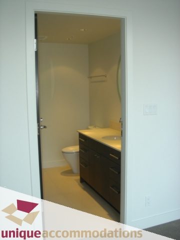 Spacious bathroom with modern vanity and sleek toilet. - 1101 -1455 Howe Street, Vancouver Downtown